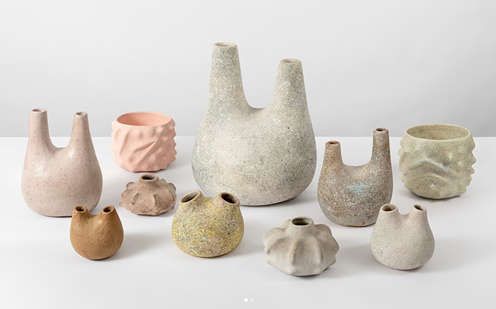 Various organic formed ceramic vases, many with two necks.